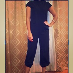 Black high neck jumpsuit. Elastic tapered leg.